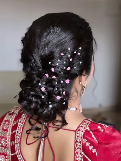 Another angle of the romantic messy updo, showing the beautiful texture and the artful placement of the floral and pearl details.