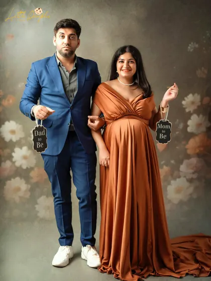 "Mom to Be" and "Dad to Be" signs are a fun way to announce your excitement. This couple's playful expressions make the shot even more special.