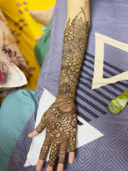 An elbow-length bridal design with a mix of floral and traditional patterns.