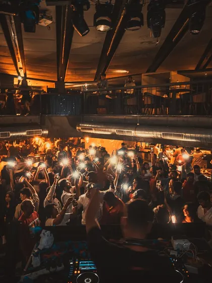 The crowd with their phone lights up at Flo.