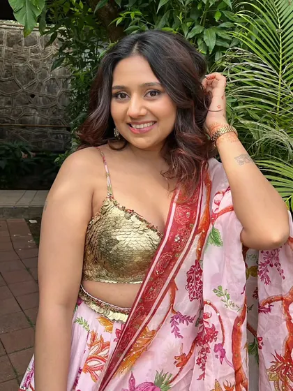 Her smile says it all. The makeup is light and enhances her features, making her feel confident and beautiful.