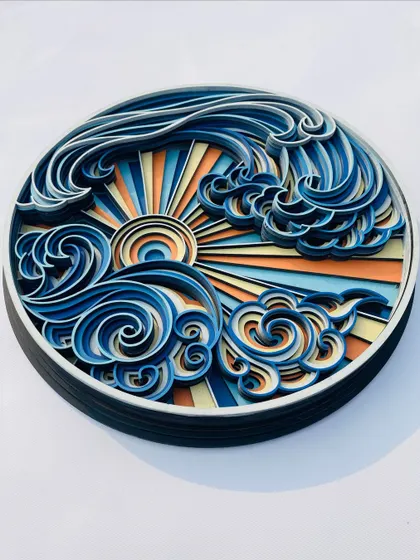 The entire Sea Wave piece, showing its circular form and the beautiful composition of the sun, clouds, and ocean waves.