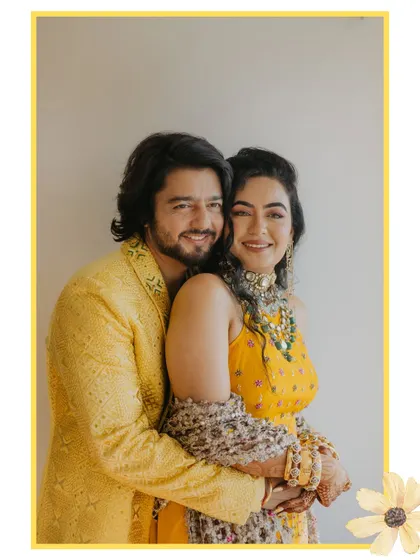 A beautifully framed portrait of the happy couple. The yellow border and floral element complement their Haldi outfits and the joyful theme of the day.