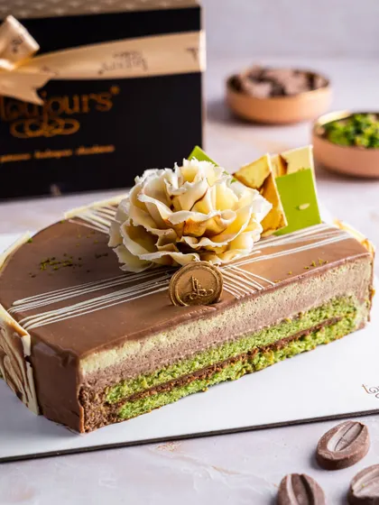A different view of our Chocolate Pistachio Entremet, showcasing the intricate layers and the elegant chocolate flower decoration. This cake is a perfect example of our patisserie skill, ready to be ordered anytime.