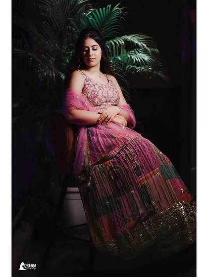 A seated portrait of Vanshika at the Mata Ki Chowki, her colorful lehenga beautifully captured in a moment of quiet grace.