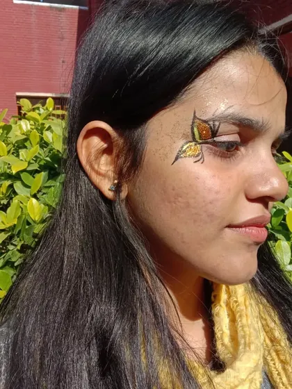 This butterfly has a beautiful stained-glass effect, with sections of orange and yellow glitter.