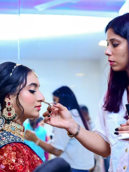 A glimpse of me in action, giving the final touches to a bride's makeup before she steps out for her big moment.