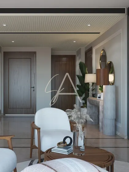 This drawing room is defined by neutral tones and minimalist patterns. The armchair and console table create a welcoming entryway, leading into the main seating area.