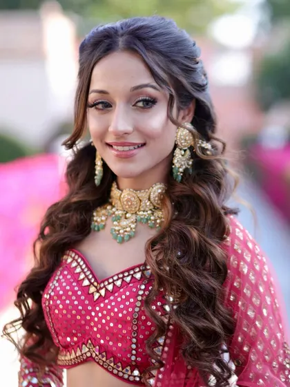 Another angle of the Bhaat look. The soft, bouncy curls and glowing makeup are perfect for an outdoor, daytime event.