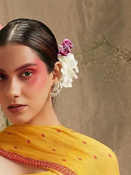 A close-up of the creative editorial makeup for Three Three Store, showing the diffused red pigment on the cheeks. This look moves beyond traditional makeup to create an artistic, painterly effect for a fashion campaign.