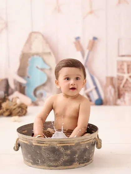 A nautical-themed splash session. We used a rustic tub and beach-themed props to create a fun, seaside-inspired bath time photo.