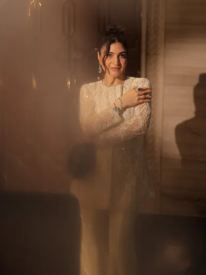 An artistic shot with a soft focus, creating a dreamy and ethereal vibe. The makeup remains flawless and elegant.