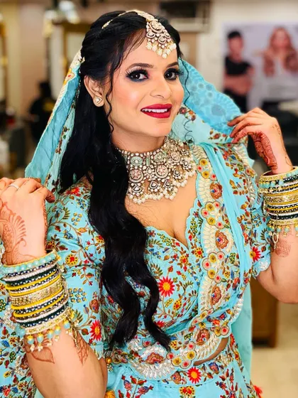 A full view of the client's joy and confidence. The makeup complements her personality and the festive occasion.