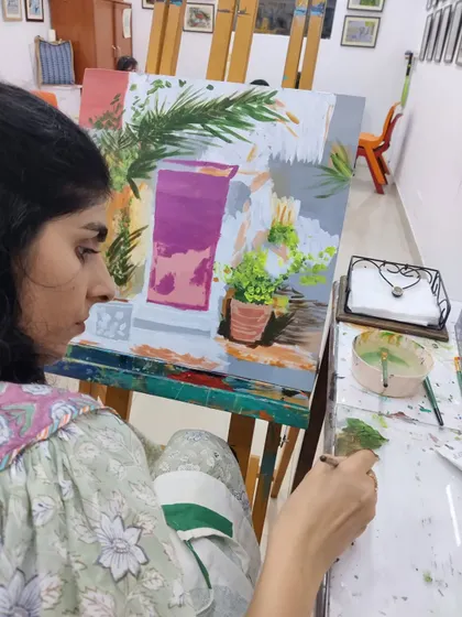 This series captures an adult student working on two different acrylic paintings, one a floral doorway and the other an abstract piece, showing the variety of styles we teach.