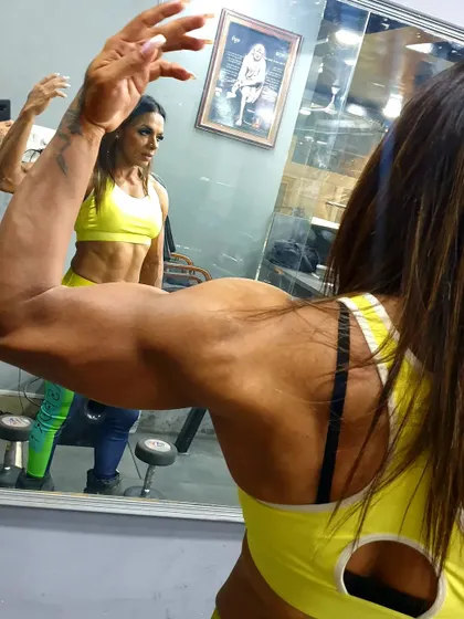 Checking the bicep gains in the mirror. This is the kind of result we work for in our arm workouts.