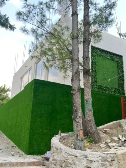 Here you can see the full project in Theog, with the framed green wall art on the upper level and a fully cladded wall on the lower level using 25mm Vietnam Grass.