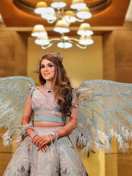 A full length portrait of the bride in her unique angel wing lehenga. We love to showcase bold and creative bridal fashion choices.