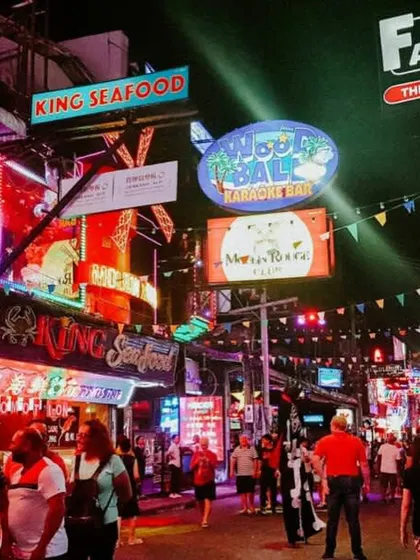 A glimpse of the vibrant and chaotic nightlife scene in Thailand's tourist hotspots. The streets are buzzing with energy, music, and food stalls.