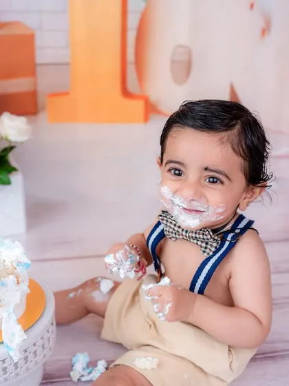 The pure delight of a cake smash. This close-up captures the messy face and happy smile that define this fun-filled session.