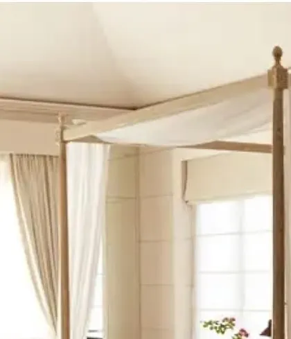 A detail shot of the four-poster bed from the Goa villa project. The light wood and draped white fabric create a breezy, elegant look perfect for a coastal home.