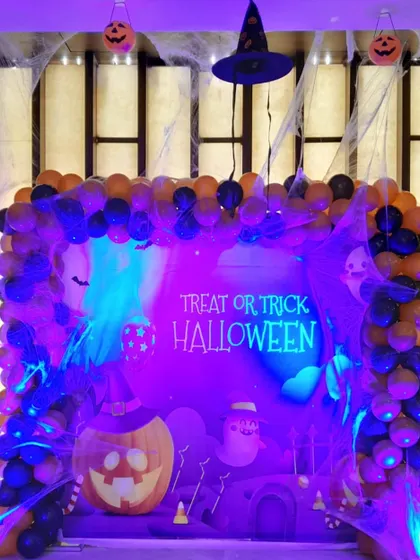The same Halloween setup viewed under different lighting, showing how I use spotlights to create a spookier, more atmospheric vibe for the event.