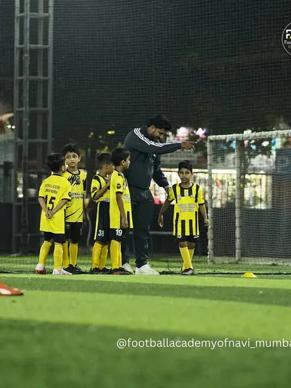 A coach points out a tactical detail to his players. I focus on developing not just physical skill, but also a player's understanding of the game.