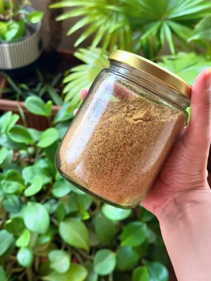 A jar of my homemade flaxseed pudi (powder). This versatile and nutritious condiment is a great way to add healthy fats, fiber, and protein to your meals.