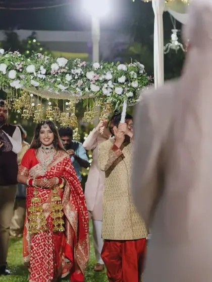 The bride's grand entrance under a beautiful 'phoolon ki chadar' made of white flowers and delicate kaleeras. I design every detail of the bridal entry to be graceful and memorable.