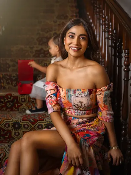 A candid moment during my shoot with Shriya Saran, as her daughter Radha plays behind her. Shriya's comment about being a working mother adds a layer of authenticity to this beautiful portrait, capturing the reality of balancing career and motherhood.