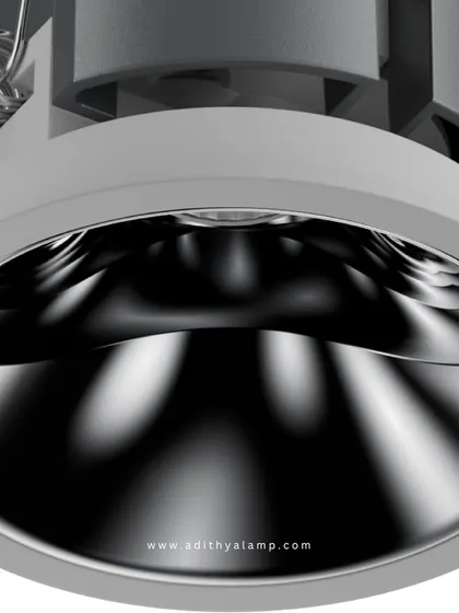 This downlight features a highly polished chrome reflector. The metallic surface creates a bright, crisp light with a distinctive pattern, adding a dynamic and modern touch to the illumination of a room.