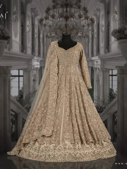 A side view of the light gold Indo-Western ensemble, showcasing its elegant silhouette and antique embellishments.