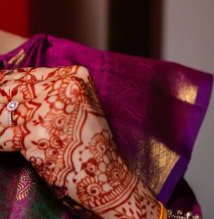 A side view of the hand, showing the beautiful stain and the elegant engagement ring.