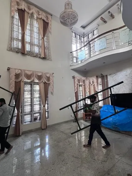 To ensure every corner is reached perfectly, my team brings in our own scaffolding and equipment. Here, we are setting up inside a client's home, ready to tackle the high walls of this beautiful living room.