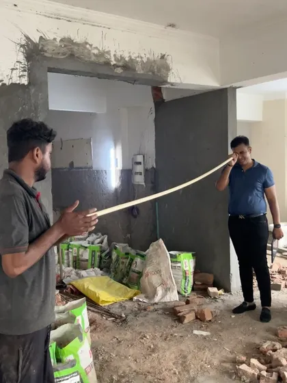 At the start of a project in Kaushambi, Ghaziabad. Here, I'm on-site during the demolition phase, planning the new layout and discussing the civil changes with my team.