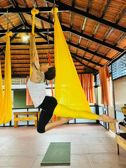 An advanced student demonstrates a deep backbend in the aerial silk, showing incredible flexibility and control.