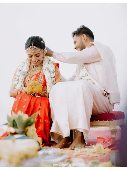 A traditional moment during the Hindu ceremony, captured with a focus on the couple's interaction.