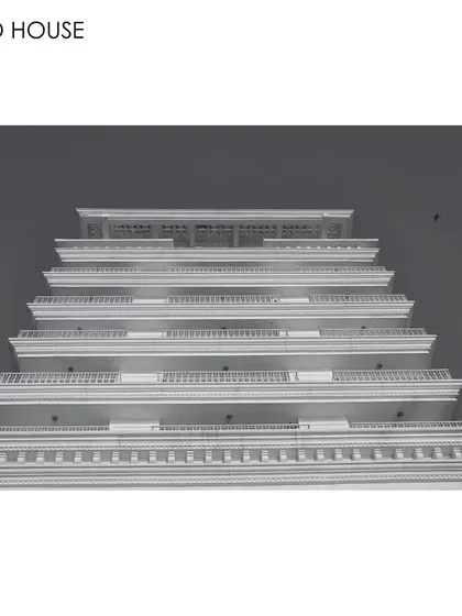 A low-angle, black and white photograph of the Soho House facade. This perspective emphasizes the building's repeating horizontal lines and classical details, celebrating the power of architecture to create inspiring and transformative spaces.