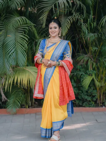 A full-length view of the stunning Paithani saree and the bride's graceful stance.