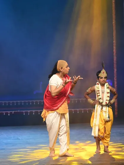 A scene with a young artist playing Krishna. Working with dancers of all ages is a wonderful part of these large scale productions.