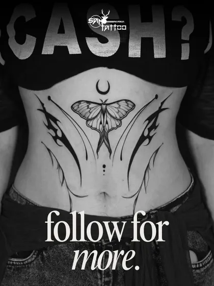 A beautifully symmetric stomach tattoo featuring a moth under a crescent moon, accented with fine-line and tribal elements.