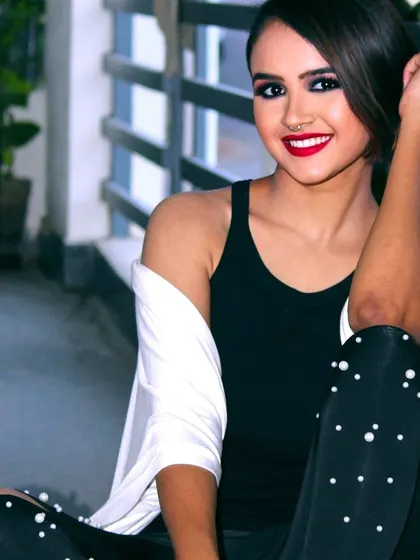 A modern and edgy party look. The intense dark smokey eye and bright red lipstick create a powerful contrast, perfect for a night out or a fashion forward event.