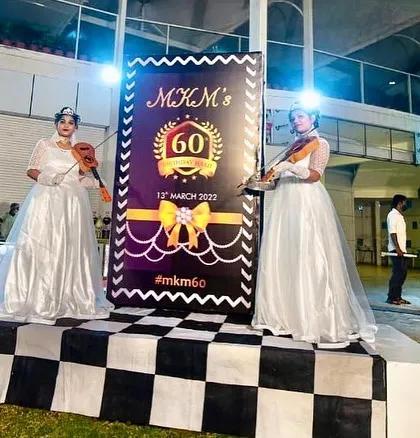 To create an atmosphere of elegance for a 60th birthday party, I had two violinists in beautiful white gowns play as guests arrived. It adds a touch of class to any entrance.