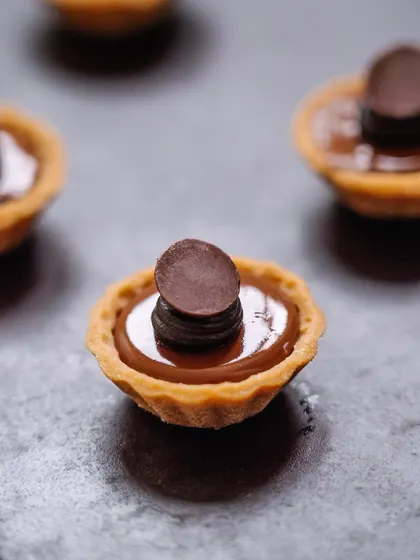 Another view of our double dark chocolate tartlets, showcasing their elegant simplicity. A perfect one-bite dessert for any occasion.