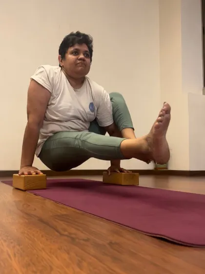 Eka Hasta Bhujasana, or Elephant's Trunk Pose, is a powerful arm balance that strengthens the wrists, arms, and core. This student is using blocks to build strength and find the correct alignment, a smart way to progress in her practice.