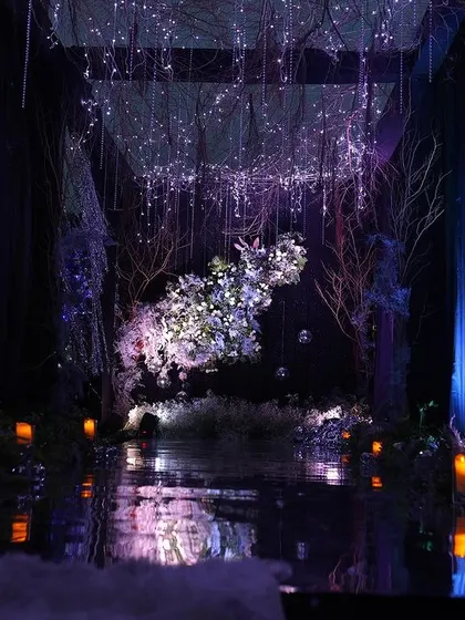 Another perspective of the enchanted forest entrance. The combination of hanging crystals, bare branches, and a floating floral arrangement creates a sense of depth and mystery.