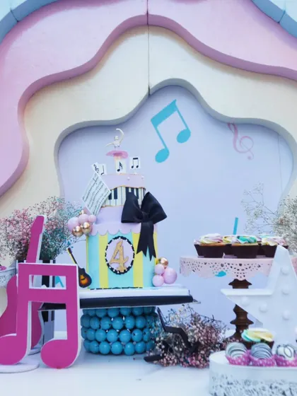 A birthday that hit all the right notes. This vibrant dessert table, set against a pastel, layered backdrop with a piano-key base, was the sweet centerpiece of a music-themed celebration.