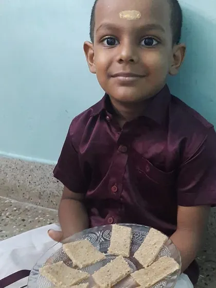 This child's pride is evident as he shares the snack he prepared. These moments are crucial for building a child's self-esteem and sense of belonging to the family and community.