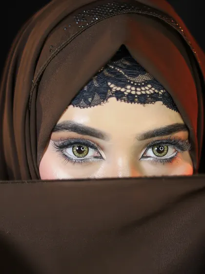A striking close-up of a full cut-crease eye makeup look on a model in a hijab, showcasing the versatility of our students' skills.