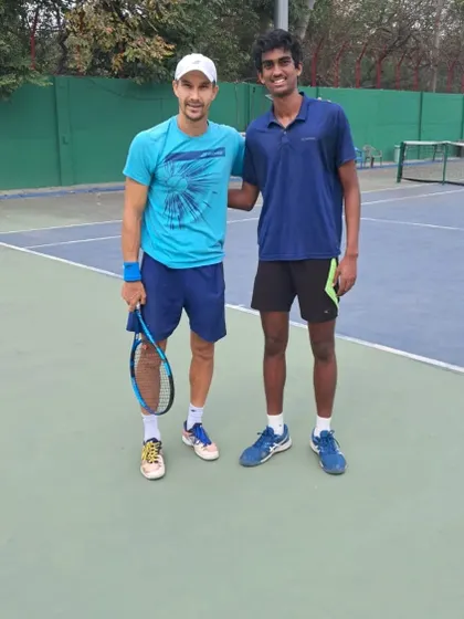 An on-court photo of our player Parth with ATP pro Tristan Boyer, an invaluable opportunity to learn from a professional.
