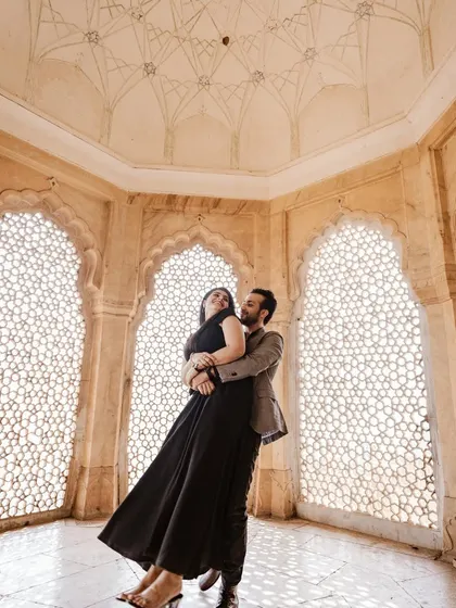 Inside the intricate marble halls of Amer Fort, we captured this moment of pure joy. The way the light filters through the jali windows creates a timeless, fine-art feel, perfect for a couple wanting elegant and romantic portraits.